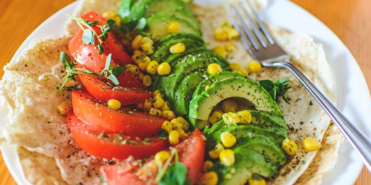 Sliced Tomato and Avocado on White Plate