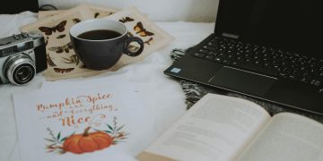 Cup of Coffee Near Laptop Computer