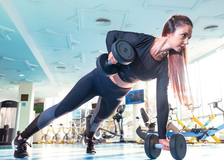 Woman Doing Exercise Inside Gym