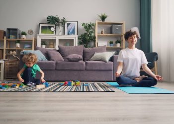 Mother Practicing Yoga and Boy Playing near