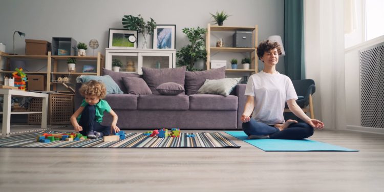 Mother Practicing Yoga and Boy Playing near