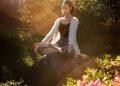 Woman Meditating on Rock