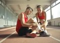 Woman Wrapping Man's Leg with Bandage