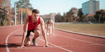 Strong sportsmen ready for running on stadium
