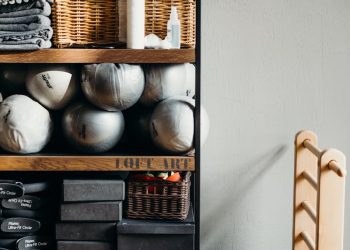White Ceramic Vase on Brown Wooden Shelf