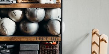 White Ceramic Vase on Brown Wooden Shelf