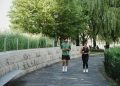 Woman and Man Jogging in Park