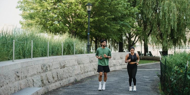Woman and Man Jogging in Park