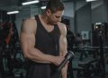 A Man Using a Massager at the Gym