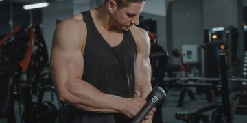 A Man Using a Massager at the Gym
