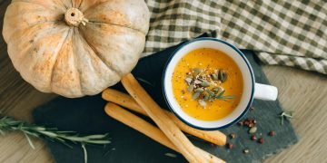 Overhead Shot of Bread Sticks and Pumpkin Soup
