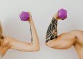 A Woman and a Man Holding Dumbbells