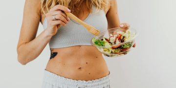 Toned Woman Eating Vegetable Salad
