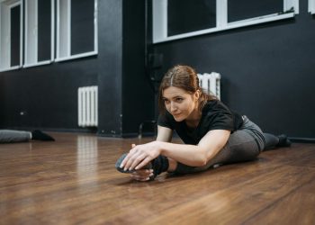Woman in a Dance Studio Doing Leg Split