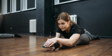Woman in a Dance Studio Doing Leg Split
