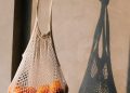 Anonymous person with bag of oranges