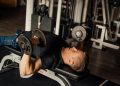 A Man Doing a Dumbbell Chest Press
