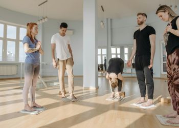 Group of People Meditating While Standing on Sadhu Boards