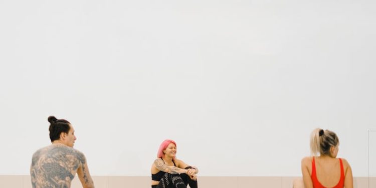 People Sitting on Swimming Boards in a Swimming Pool