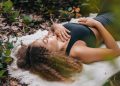 Woman Wearing Black Tank Top Lying on White Towel